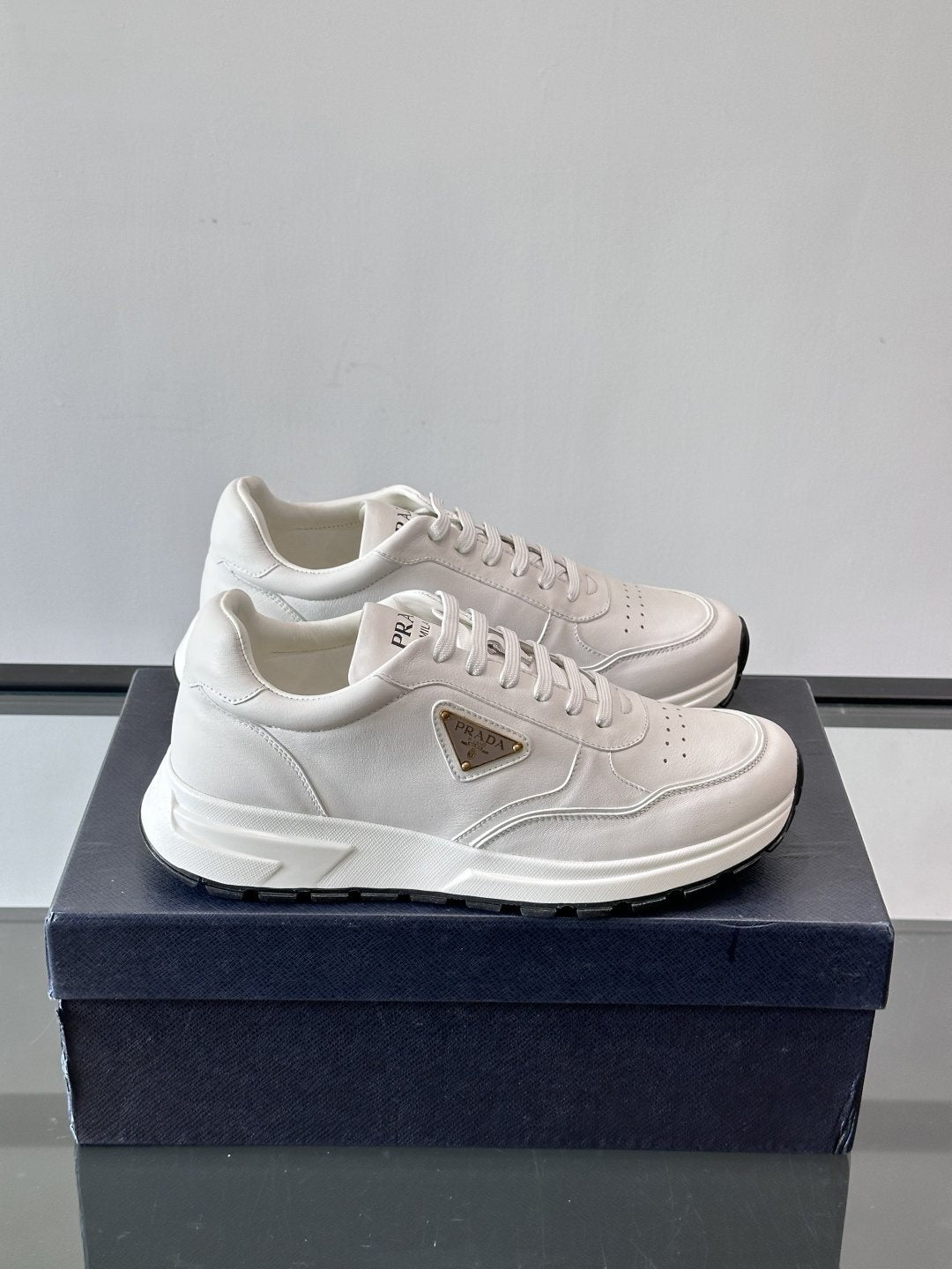 Prada Triangle Plaque Low-Top Sneakers — front